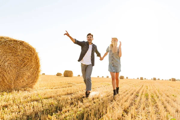 Glada Unga Par Promenader Tillsammans Fältet Vete Hålla Händerna Pekar — Stockfoto