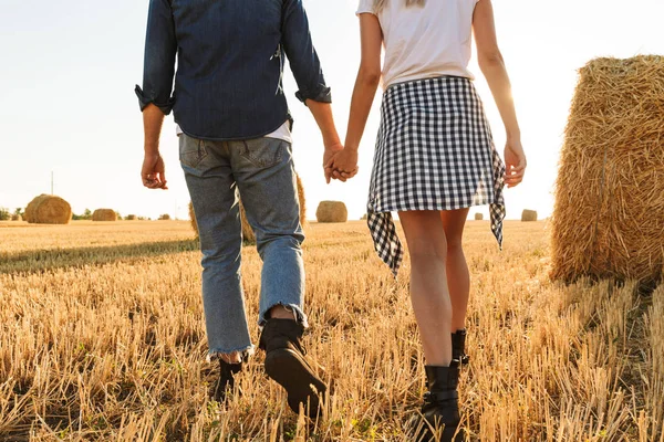 Cropped Photo Young Guy Girl Walking Golden Field Bunch Haystacks — Stock Photo, Image