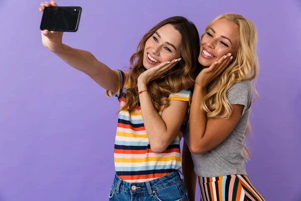 Dos Amigas Jóvenes Muy Lindas Pie Aisladas Sobre Fondo Violeta —  Fotos de Stock