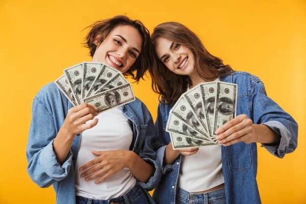 Image Happy Women Friends Isolated Yellow Wall Background Holding Money — Stock Photo, Image