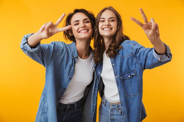 Imagem Felizes Emotivas Jovens Amigas Posando Isolado Sobre Fundo Amarelo — Fotografia de Stock