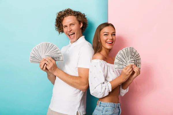 Portrait Happy Young Couple Standing Two Colored Background Showing Money — Stock Photo, Image