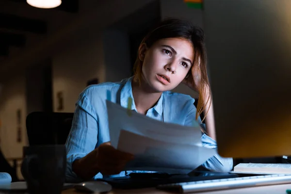 Image of beautiful young woman graphic designer using pc computer working with documents at night in office.