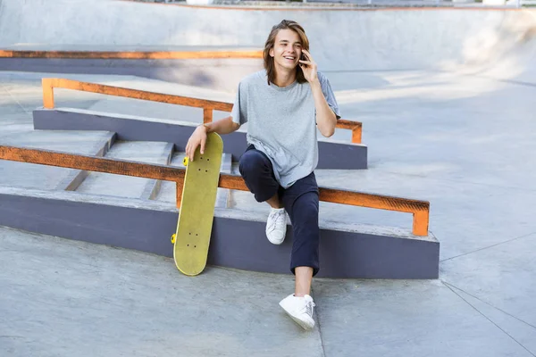 Imagen Del Guapo Joven Patinador Sentado Parque Con Monopatín Hablando — Foto de Stock