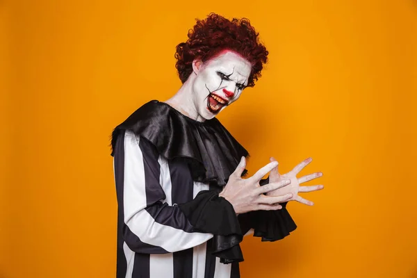 A Man Costumed as Pennywise Making Scary Face Reaction · Free Stock Photo