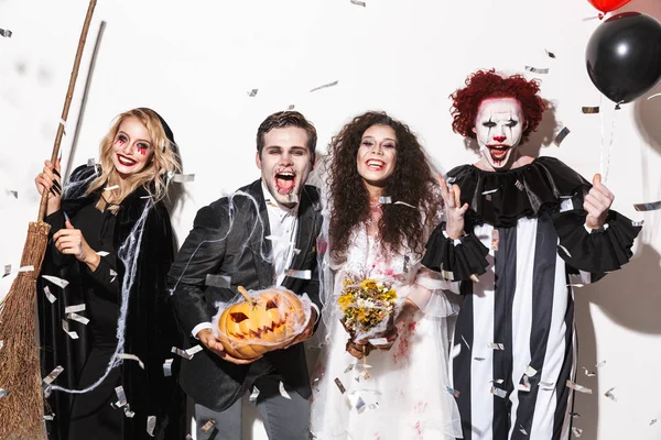 Group Joyful Friends Dressed Scary Costumes Celebrating Halloween Confetti Rain — Stock Photo, Image