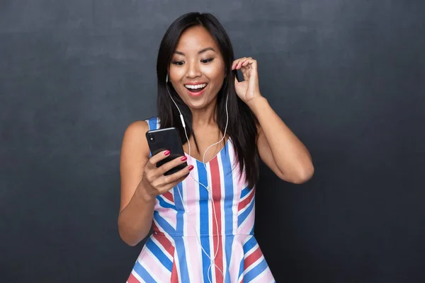 Image Delighted Asian Woman 30S Wearing Earphones Using Black Mobile — Stock Photo, Image