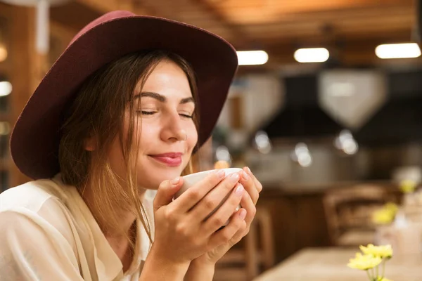 Close Delighted Girl Hat Sitting Cafe Table Indoors Holding Cup — Stock Photo, Image