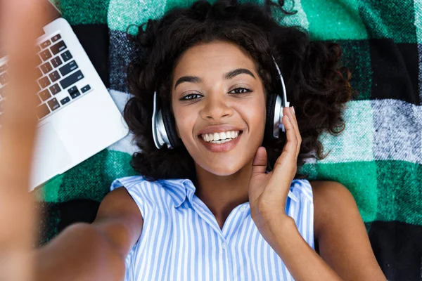 Top View Smiling African Woman Lying Blanket Laptop Listening Music — Stock Photo, Image