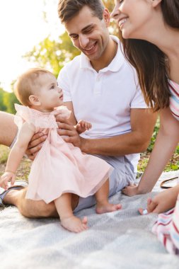 Mutlu genç ailesinin piknik parkta, birlikte vakit küçük bebeği ile yakın çekim