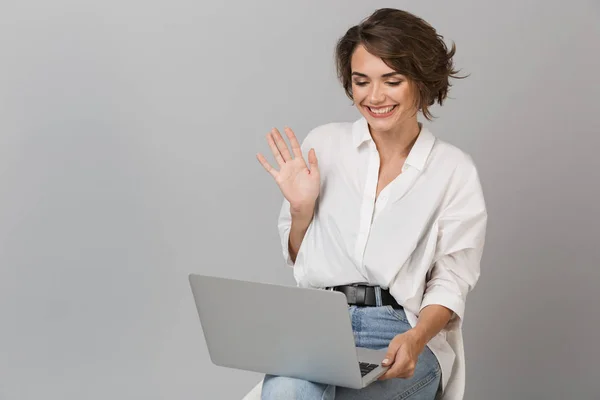 Photo Happy Young Woman Sitting Stool Isolated Grey Background Holding — Stock Photo, Image