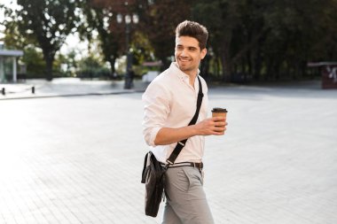 Neşeli işadamı açık havada şehir street yürüyüş, paket servisi olan restoran kahve holding, uzağa arıyorsunuz gömlek giymiş