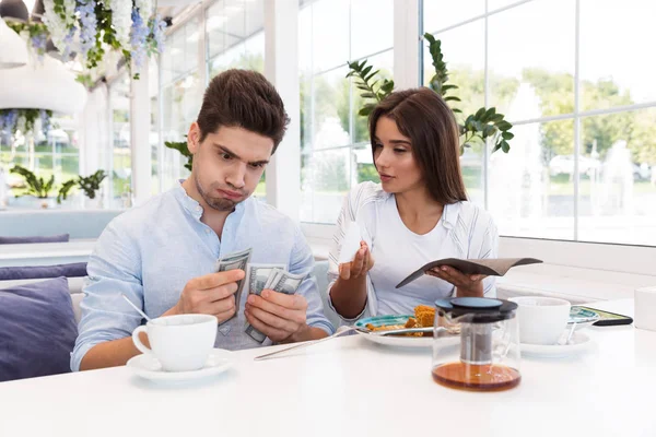 Imagem Jovem Descontente Casal Amoroso Confuso Sentado Café Segurando Cheque — Fotografia de Stock