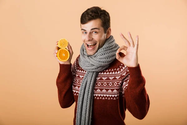 Portrait Happy Man Dressed Sweater Scarf Isolated Beige Background Holding — Stock Photo, Image