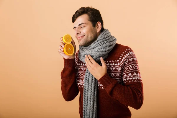 Portrait Delighted Man Dressed Sweater Scarf Isolated Beige Background Holding — Stock Photo, Image