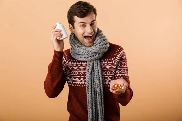 Portrait Excited Man Dressed Sweater Scarf Isolated Beige Background Holding — Stock Photo, Image