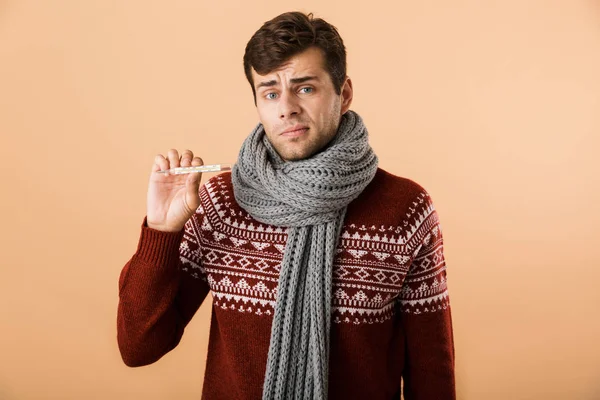 Portrait Confused Sick Young Man Dressed Sweater Scarf Isolated Beige — Stock Photo, Image