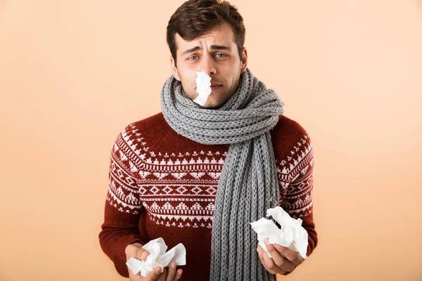 Portrait Sick Young Man Dressed Sweater Scarf Isolated Beige Background — Stock Photo, Image