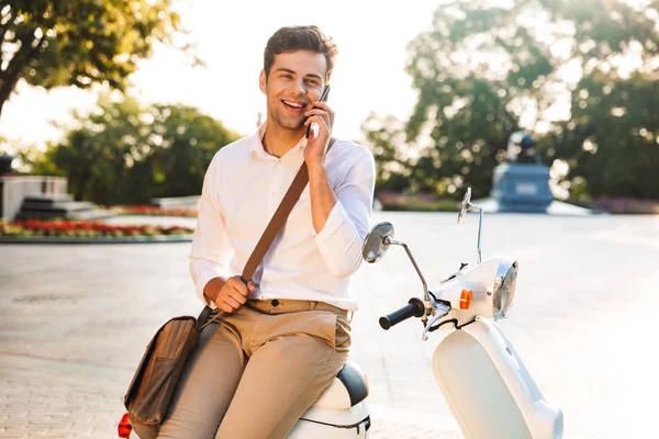 Happy Young Businessman Sitting Motorbike Outdoors Talking Mobile Phone — Stock Photo, Image