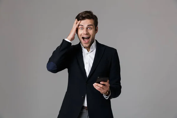 Image Delighted Man 30S Business Suit Using Black Mobile Phone — Stock Photo, Image