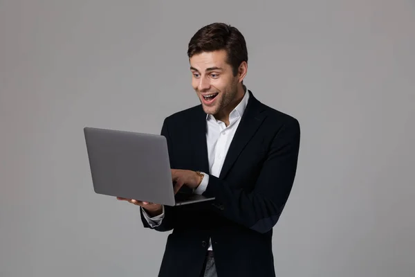 Portrait Delighted Young Businessman Dressed Suit Isolated Gray Background Using — Stock Photo, Image