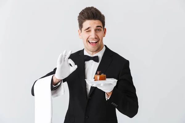 Handsome Young Waiter Tuxedo Bowtie Holding Plate Cake Isolated White — Stock Photo, Image