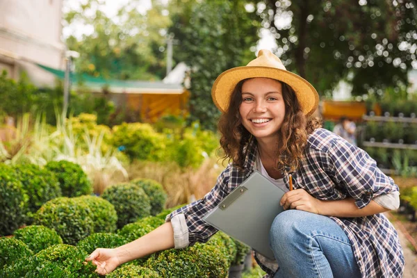 Happy Young Woman Working Greenhouse Writing Notes Notepad — Stock Photo, Image