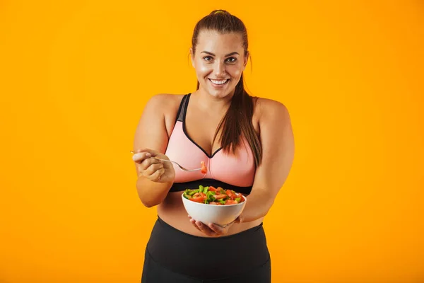Image Big Sportswoman Tracksuit Eating Green Salad Plate Isolated Yellow — Stock Photo, Image
