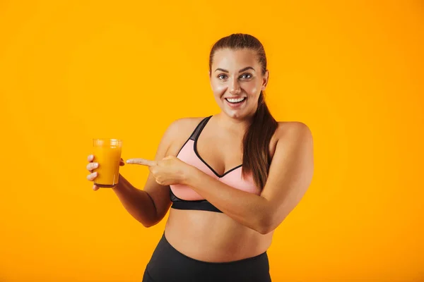 Image Joyful Chubby Woman Tracksuit Smiling Holding Glass Orange Juice — Stock Photo, Image