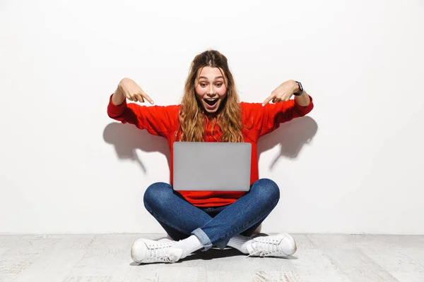 Portrait Excited Young Woman Wearing Hoodie Sitting Isolated White Background — Stock Photo, Image