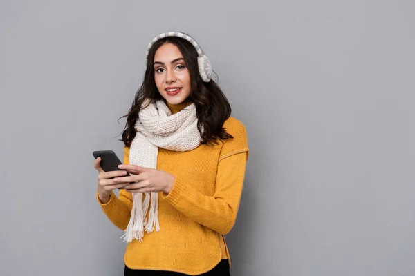 Portrait Positive Woman Wearing Ear Muffs Scarf Holding Mobile Phone — Stock Photo, Image