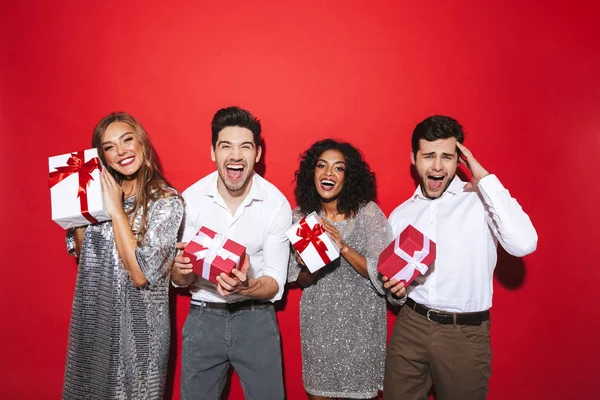 Group Four Cheerful Smartly Dressed Friends Standing Isolated Red Background — Stock Photo, Image