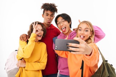 Neşeli Genç beyaz arka plan üzerinde izole sırt çantaları, bir selfie alarak taşıyan grup