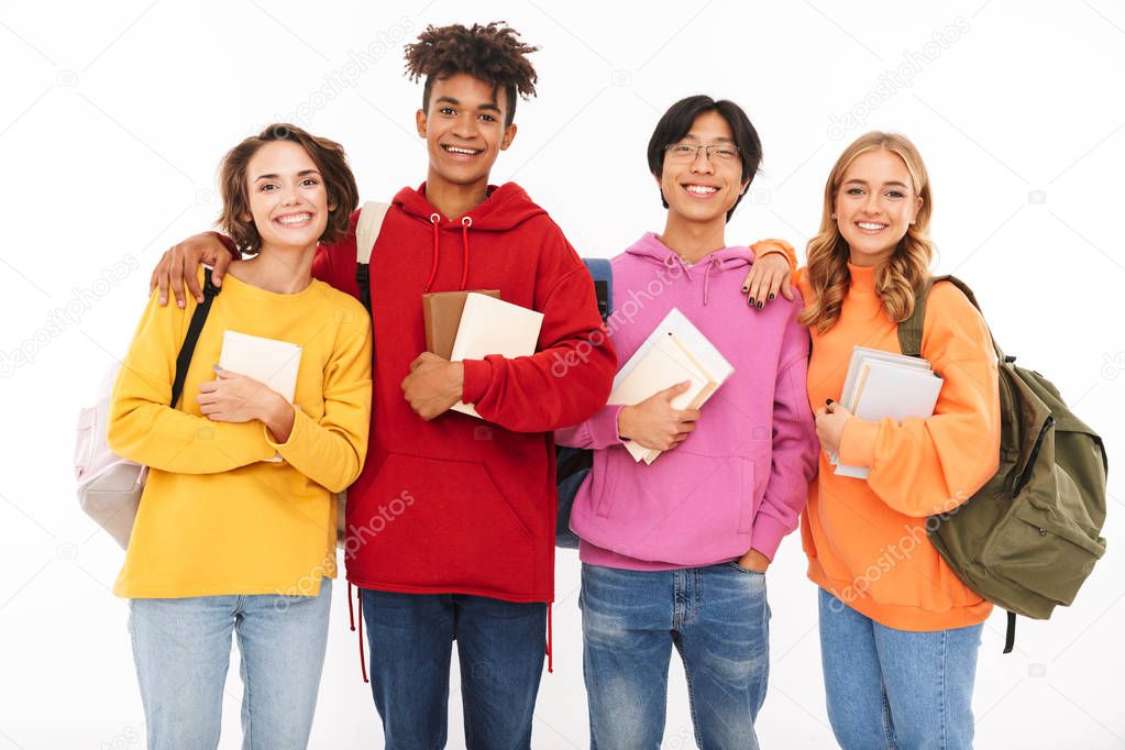 Photo of emotional young group of friends students standing isolated over white wall background posing.