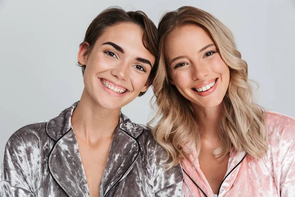 Two Cheerful Girls Wearing Pajamas Standing Isolated Gray Background — Stock Photo, Image