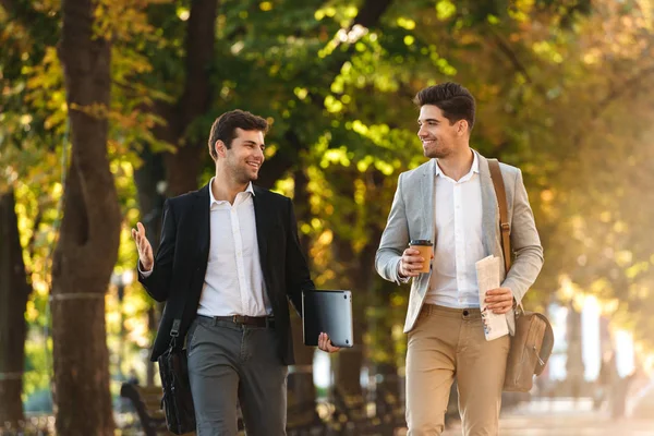 Two Happy Businessmen Walking Outdoors Drinking Coffee Talking — Stock Photo, Image