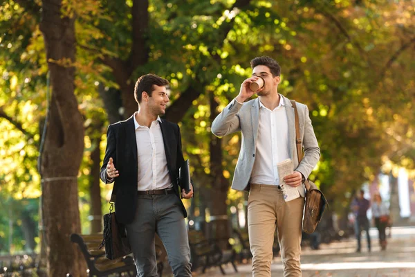 Two Happy Businessmen Walking Outdoors Drinking Coffee Talking — Stock Photo, Image