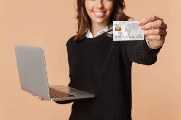 Excited Young Woman Wearing Sweater Holding Laptop Computer Showing Plastic — Stock Photo, Image