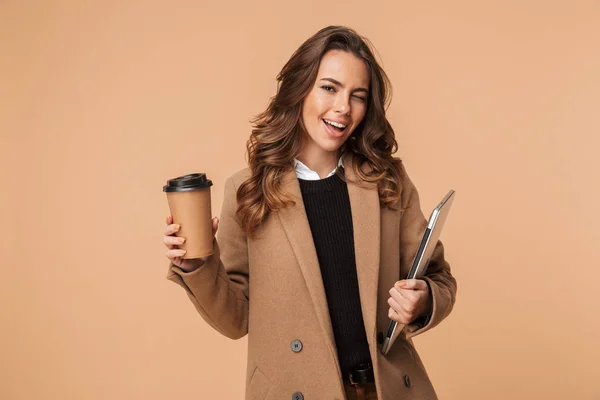 Mujer Joven Sonriente Usando Abrigo Aislado Sobre Fondo Beige Llevando —  Fotos de Stock