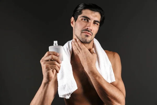 英俊的无袖男子与毛巾在他的肩膀上站在黑色背景孤立 应用后剃须 — 图库照片