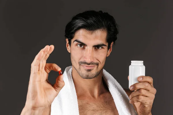 Image Handsome Young Man Isolated Dark Background Towel Holding Pills — Stock Photo, Image