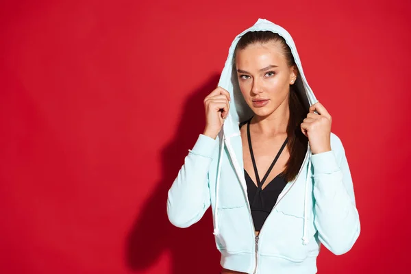 Portrait Beautiful Fit Young Sportswoman Wearing Hoodie Standing Red Background — Stock Photo, Image