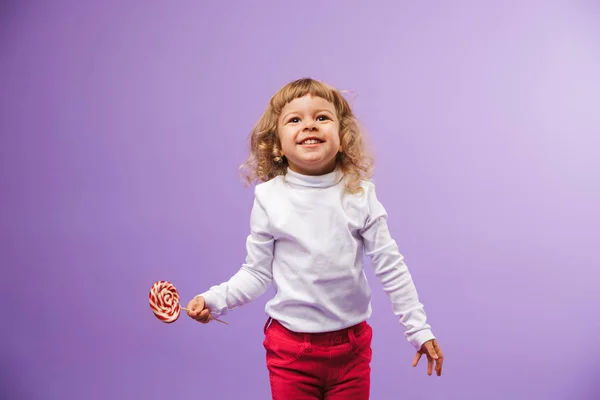 Cheerful Little Girl Holding Christmas Lollipop Isolated Violet Background — Stock Photo, Image