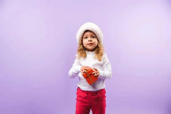 Cheerful Little Girl Holding Christmas Present Box Isolated Violet Background — Stock Photo, Image