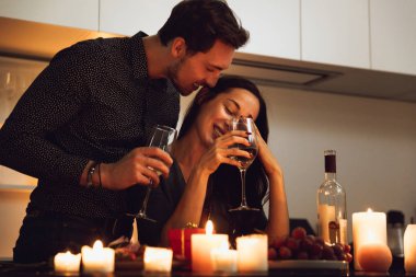 Evde mum ışığında romantik bir akşam yemeği, öpüşme güzel tutkulu Çift