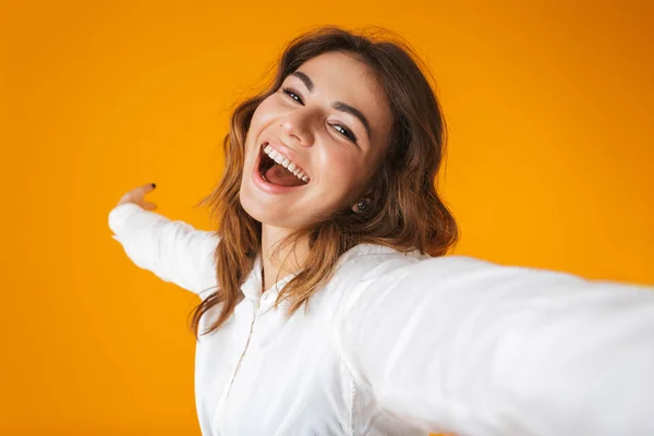 Portrait of a cheerful young woman wearing white shirt — Stock Photo, Image