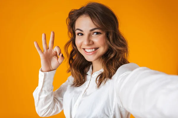Portrait of a cheerful young woman wearing white shirt — Stock Photo, Image