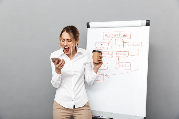 Image of displeased businesswoman in formal wear screaming on ce — Stock Photo, Image