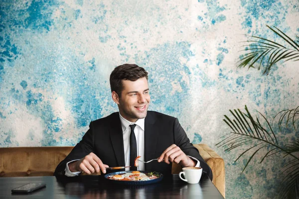 Handsome young businessman sitting in cafe have a breakfast or dinner eat. — Stock Photo, Image