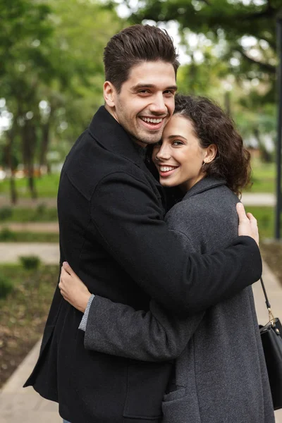 Portrait of loving couple man and woman 20s hugging, and walking — Stock Photo, Image